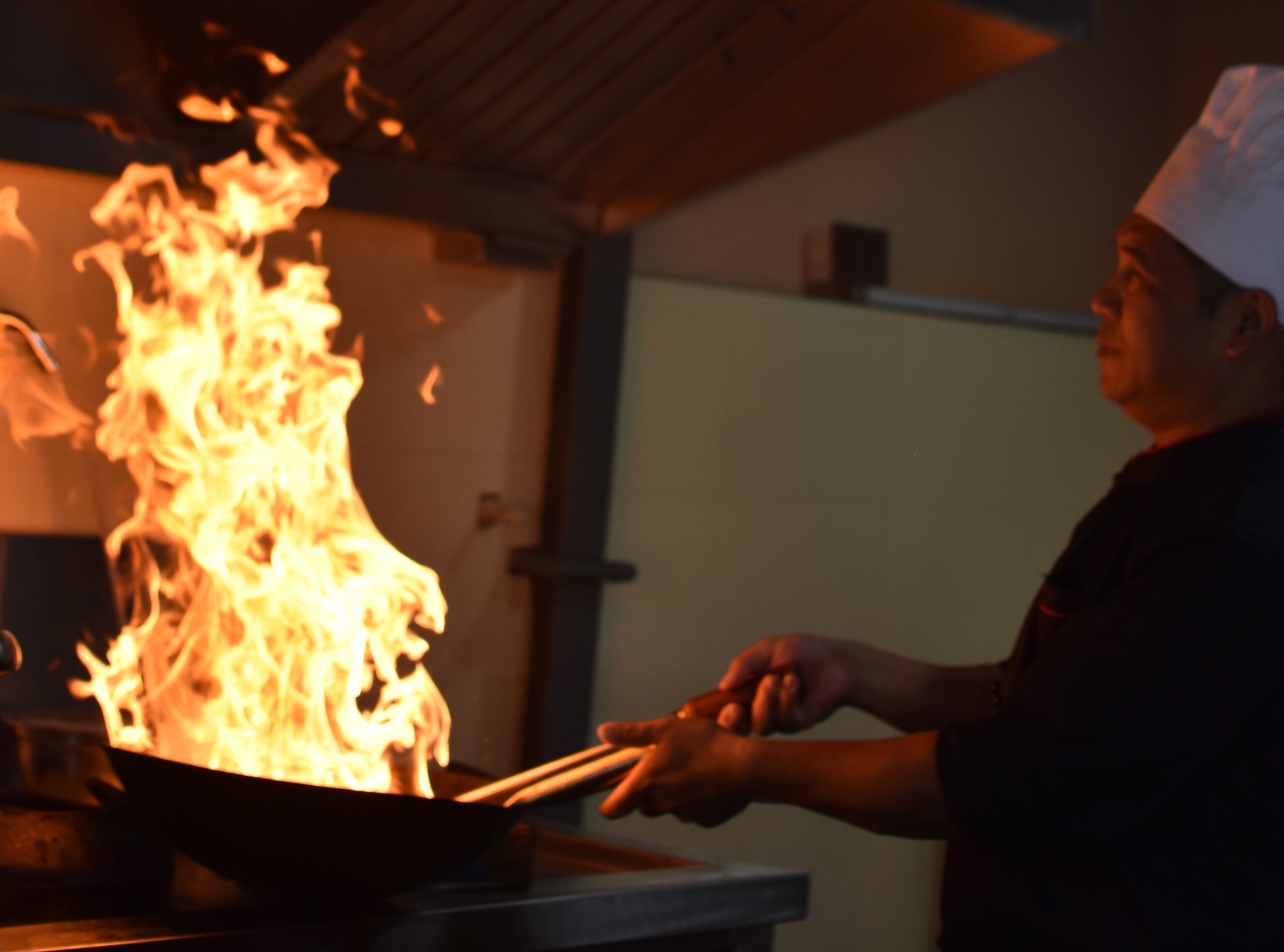 Wok cooking over fire at Pokhara Chinese Restaurant